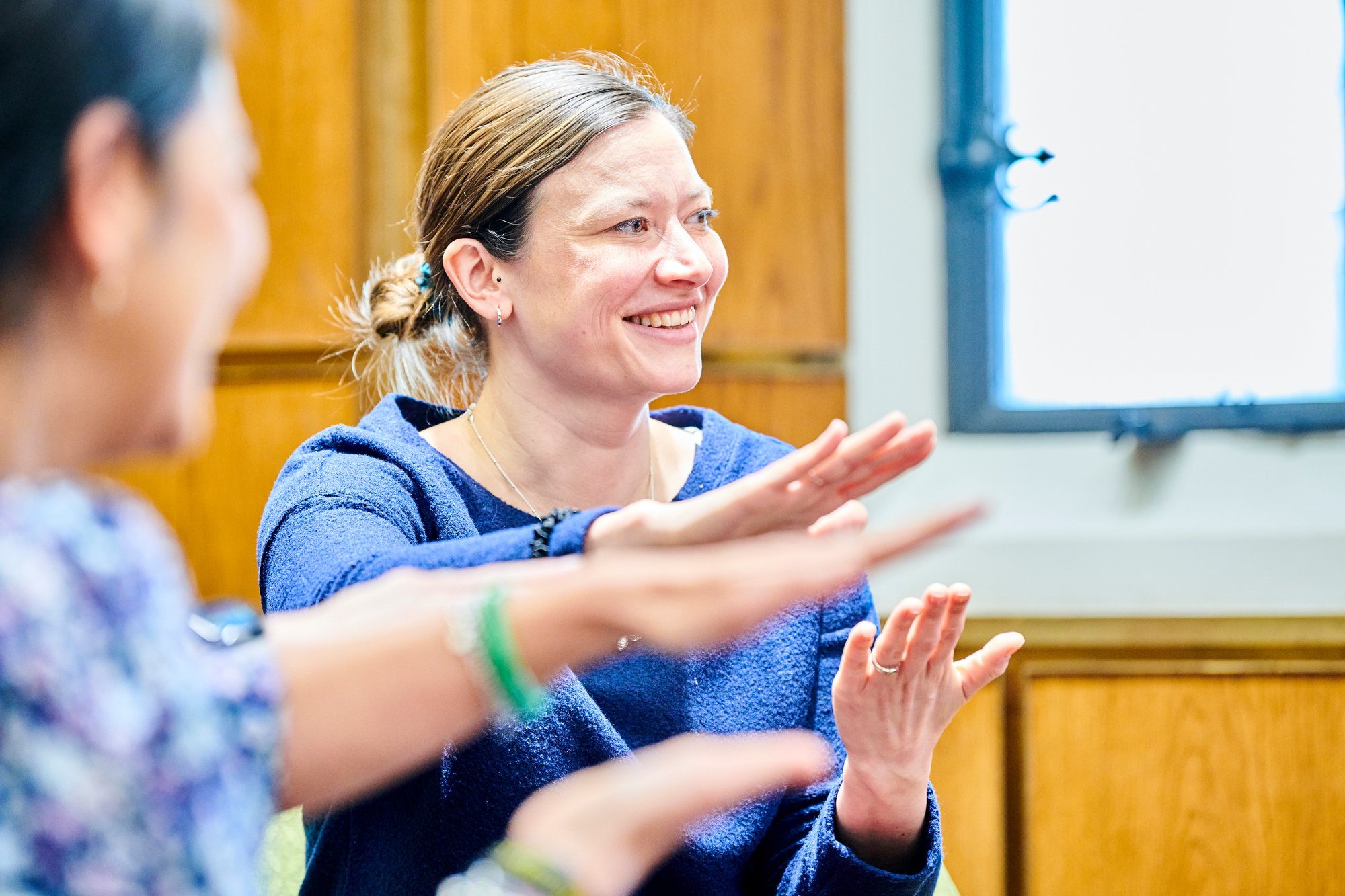 A woman learning sign language at the Equality, Diversity, and Inclusion workshop.