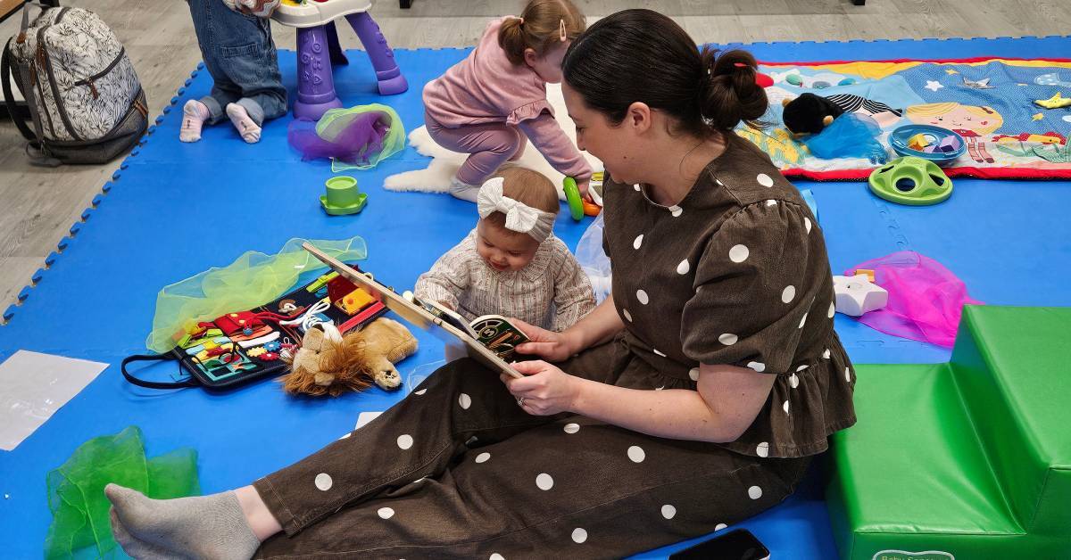 A mum reads to her baby during a session at Babyzone Grimsby. Photo credit. Babyzone.