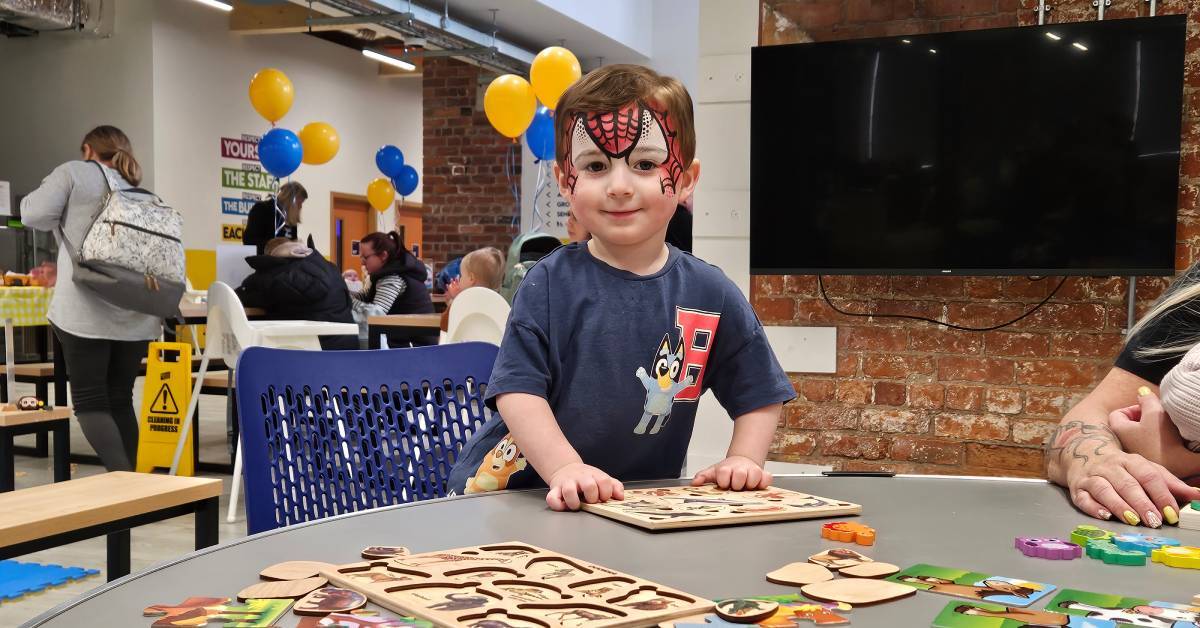 A young visitor with face paint explores the activity table at Babyzone Grimsby. Photo credit. Babyzone.