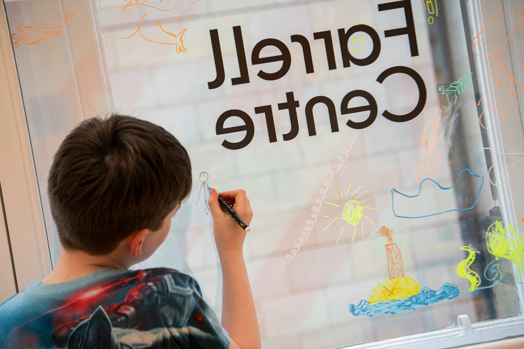 Child writing in Farrell Centre
