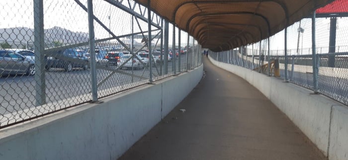 A fenced-off walkway near the US-Mexico border.