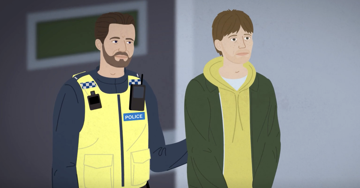 A police officer accompanies an arrested man to the police station.
