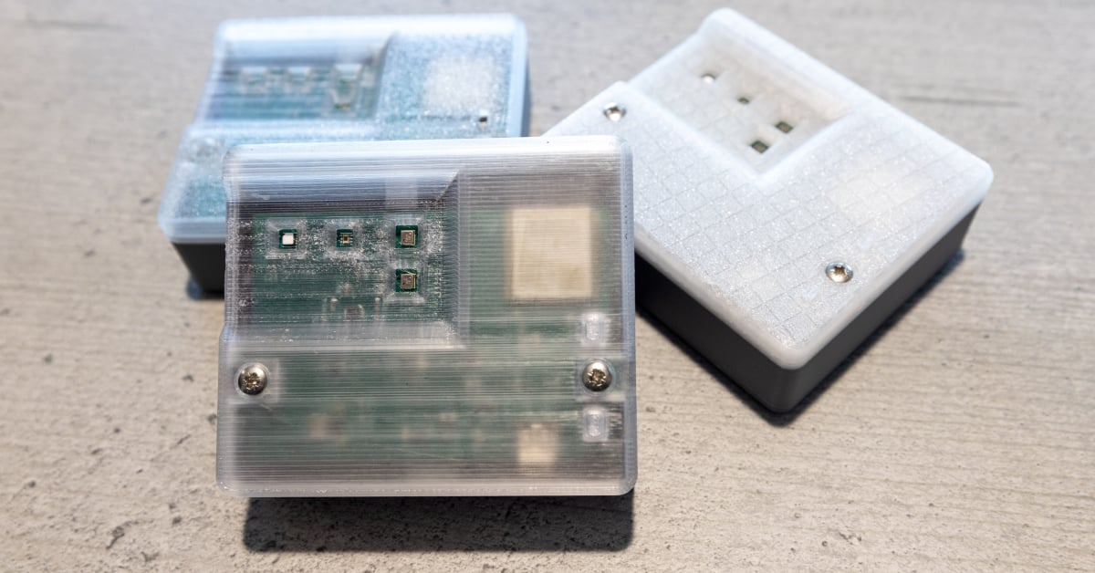 Three electronic sensors contained within white cases.