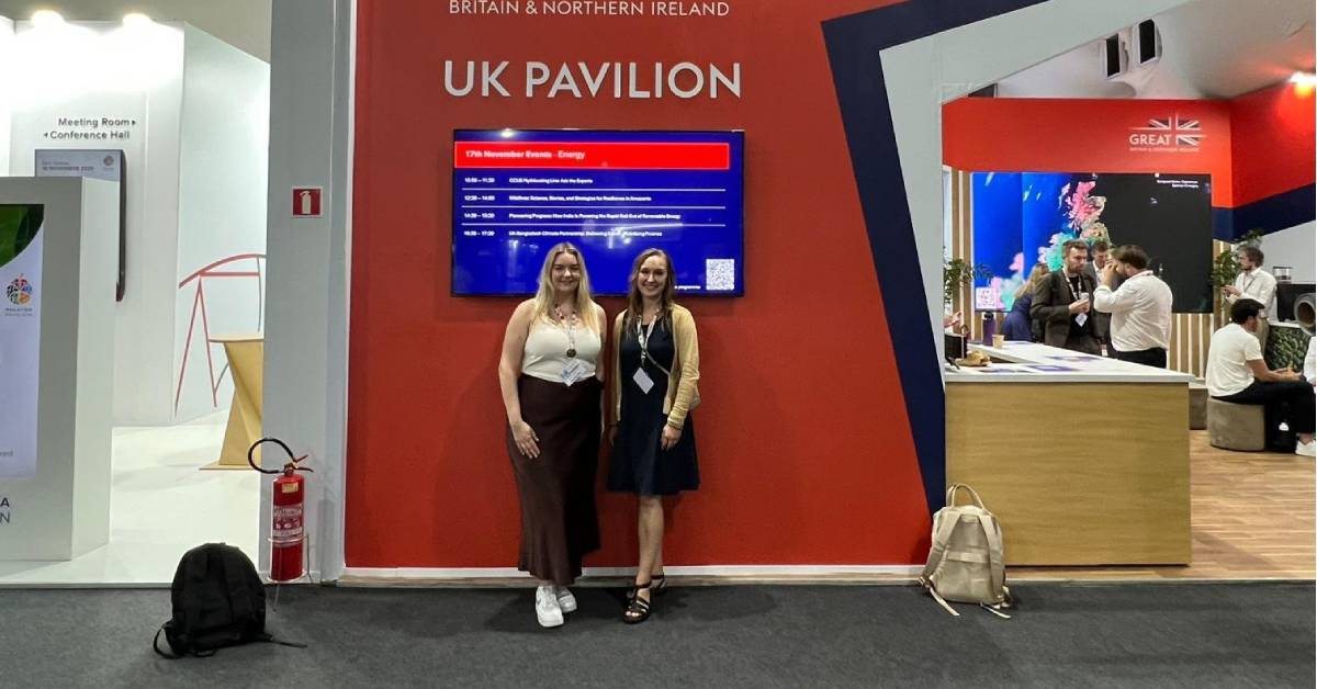 Kristina Wolf and Amy Neild stand outside the entrance to the UK Pavillion at COP30