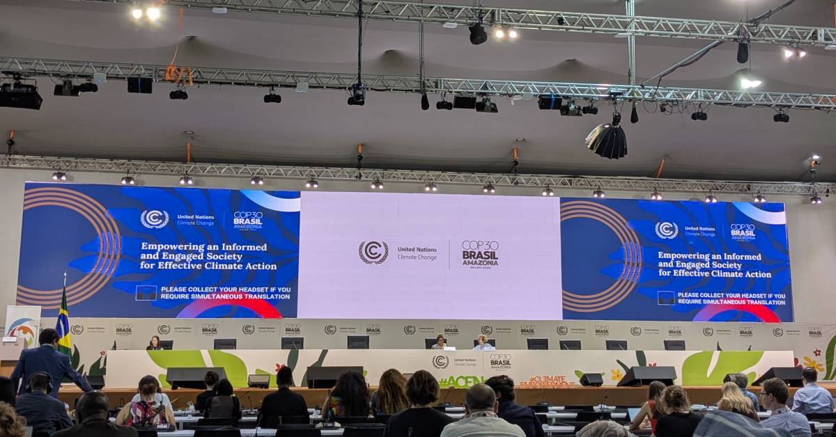 View from the audience of a panel discussion about to start on stage, entitled 