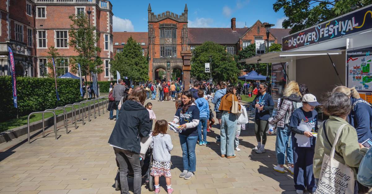 image shows Newcastle University campus with crowds excited to attend