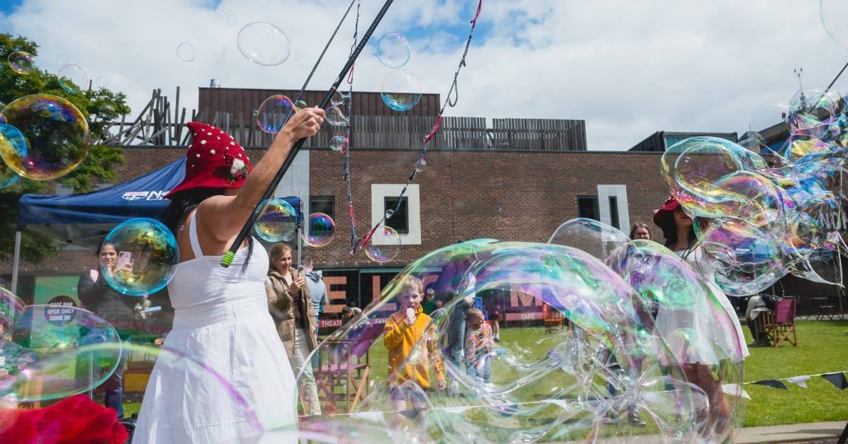 image shows giant bubbles floating across campus