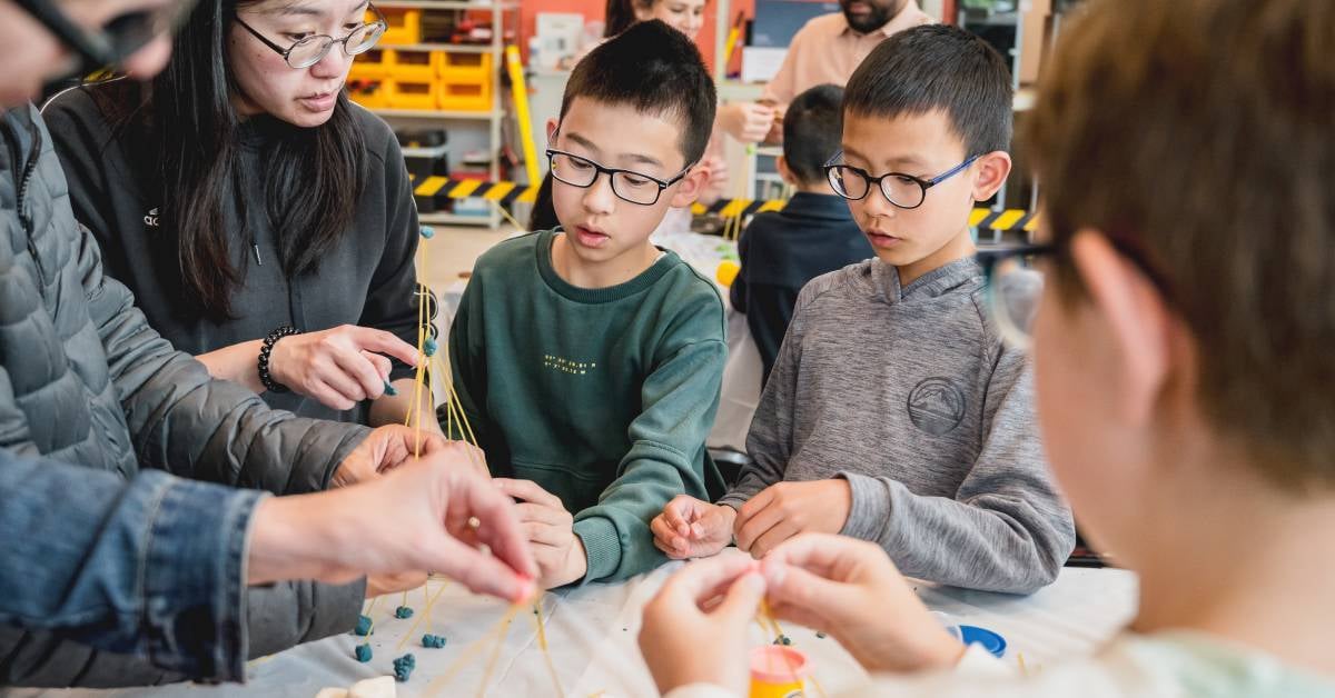 image shows a family engaging with a science activity