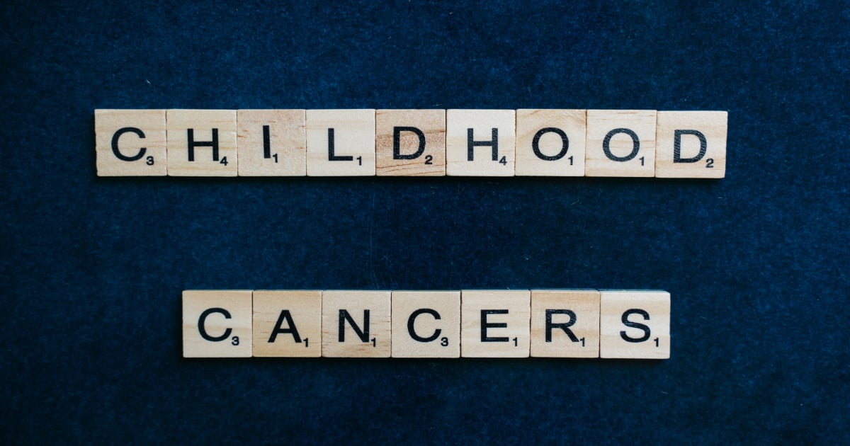 Wooden Scrabble letters spelling out 'Childood Cancers'