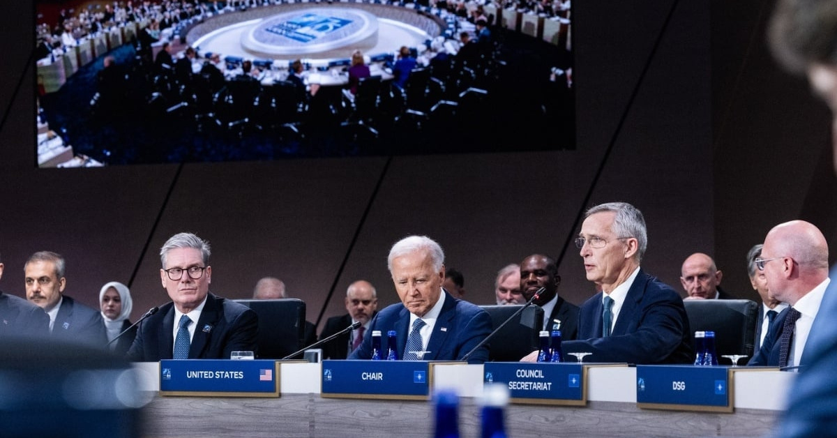 Sir Keir Starmer and Joe Biden sit with other delegates at the NATO Summit.