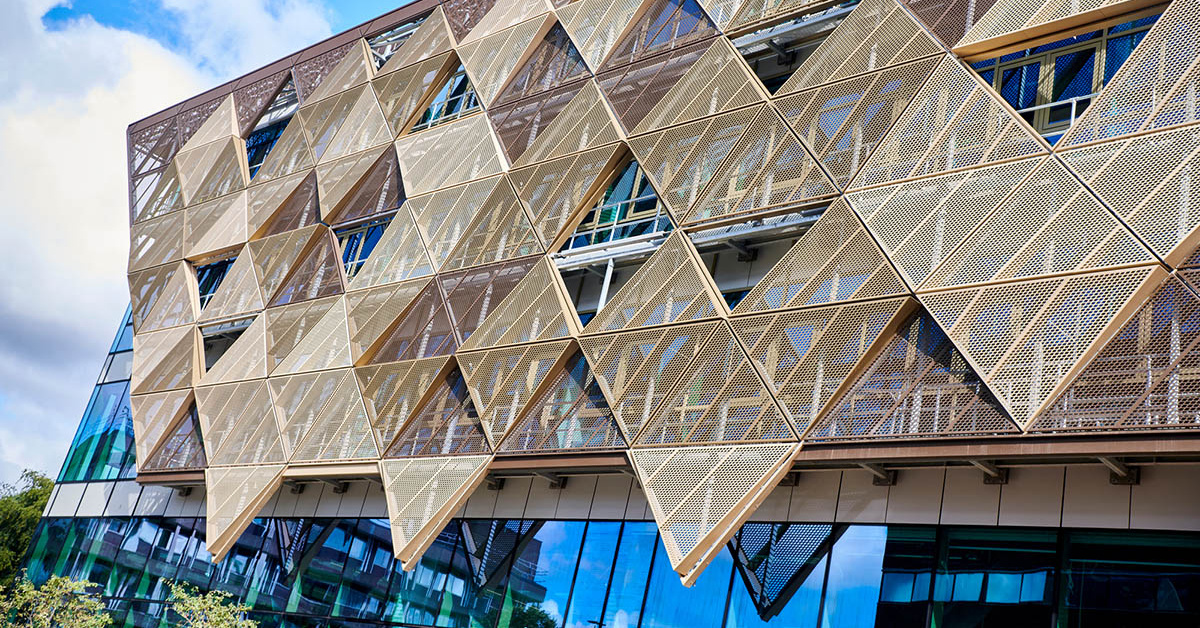 The Stephenson Building at Newcastle University set against a blue sky, photographed at an angle.