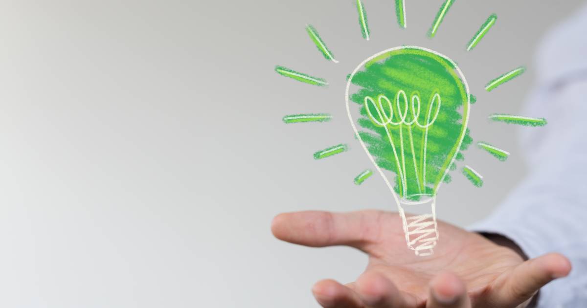 Green idea lightbulb icon above an open palm