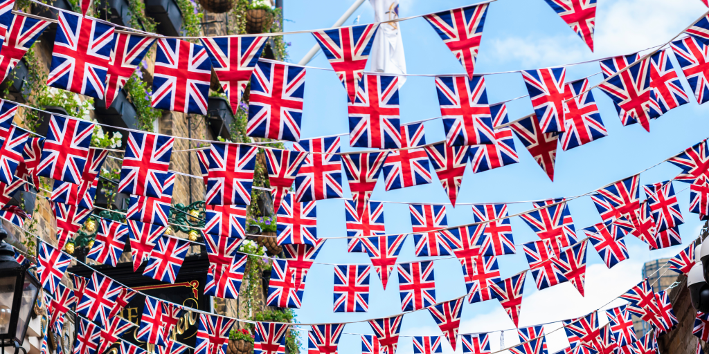 Bunting printed with the Union Jack flag hangs from buildings