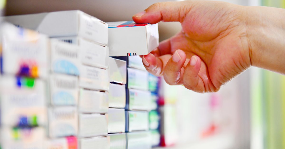 pharmacist_taking_medication_off_shelf